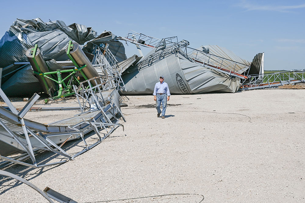 Ron Heck surveys damage caused by the derecho on August