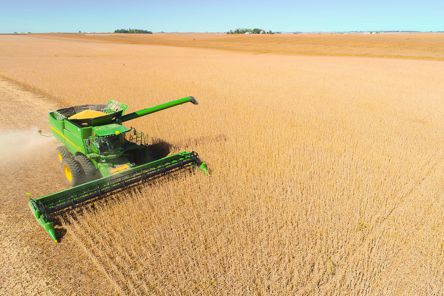 John Deere combine in soybean field during harvest