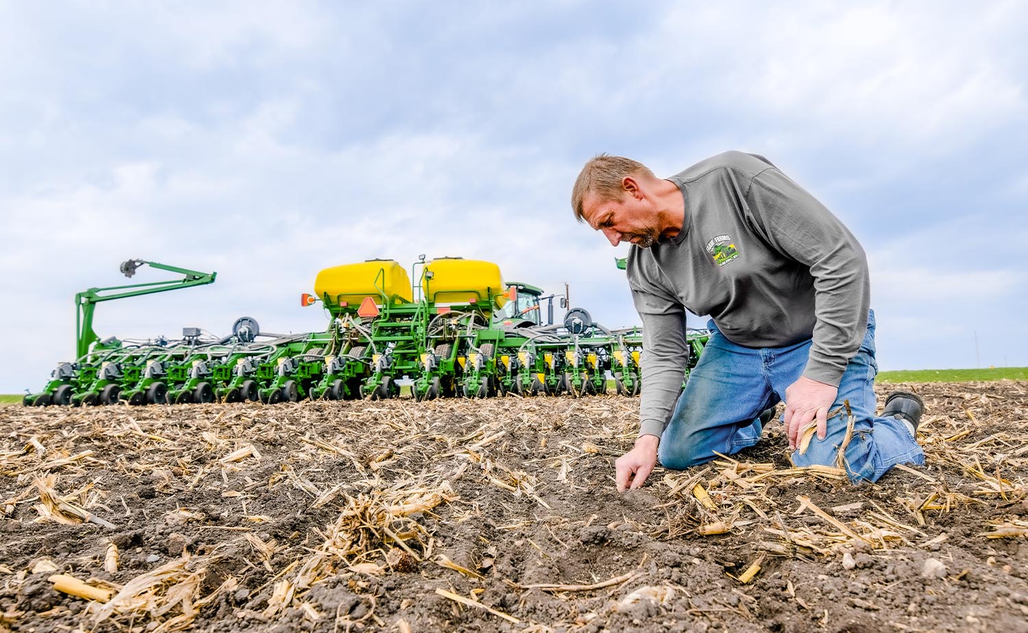 Iowa soybean farmer in field with John Deere planter