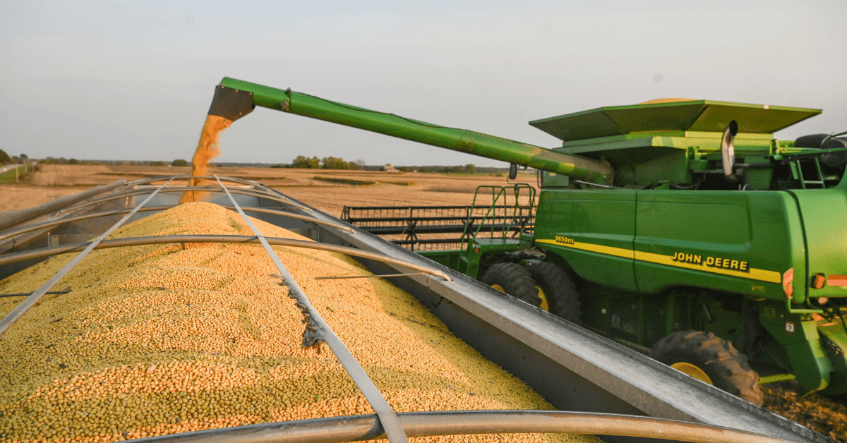 Combine unloads soybeans into semi.
