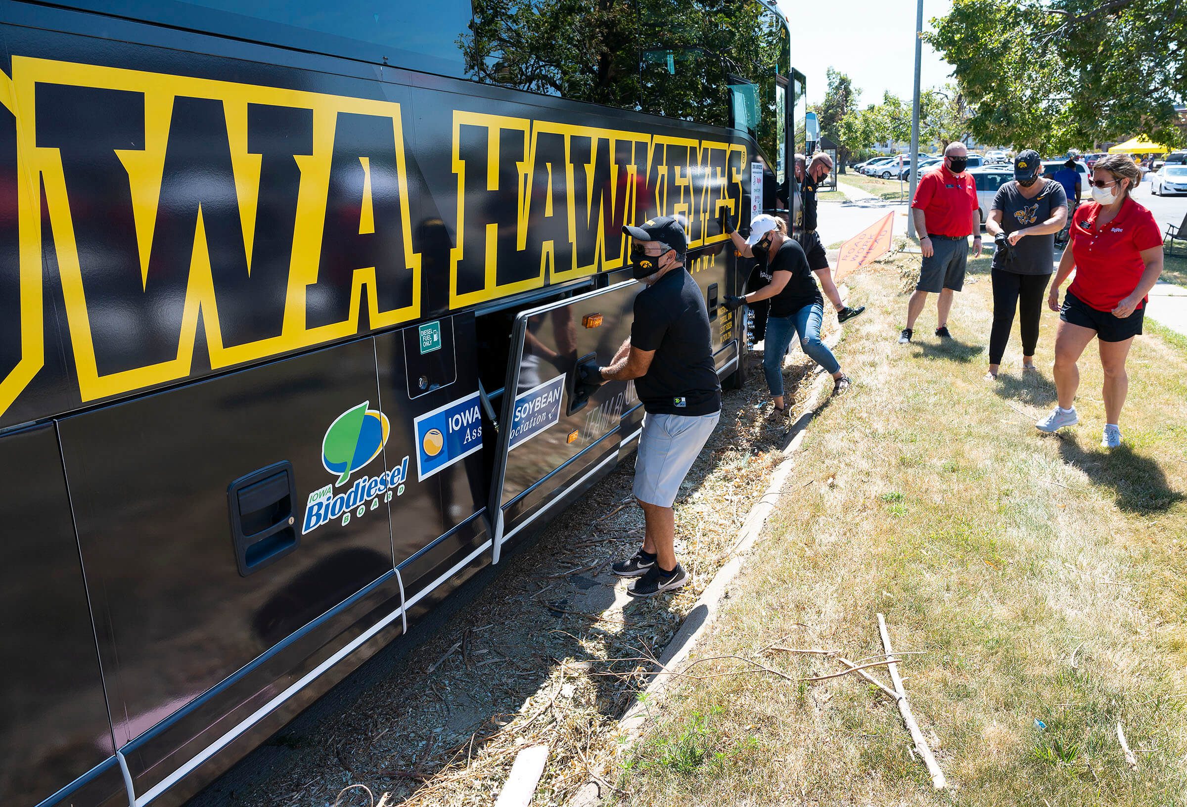 Iowa Hawkeye team bus with people outside of it wearing