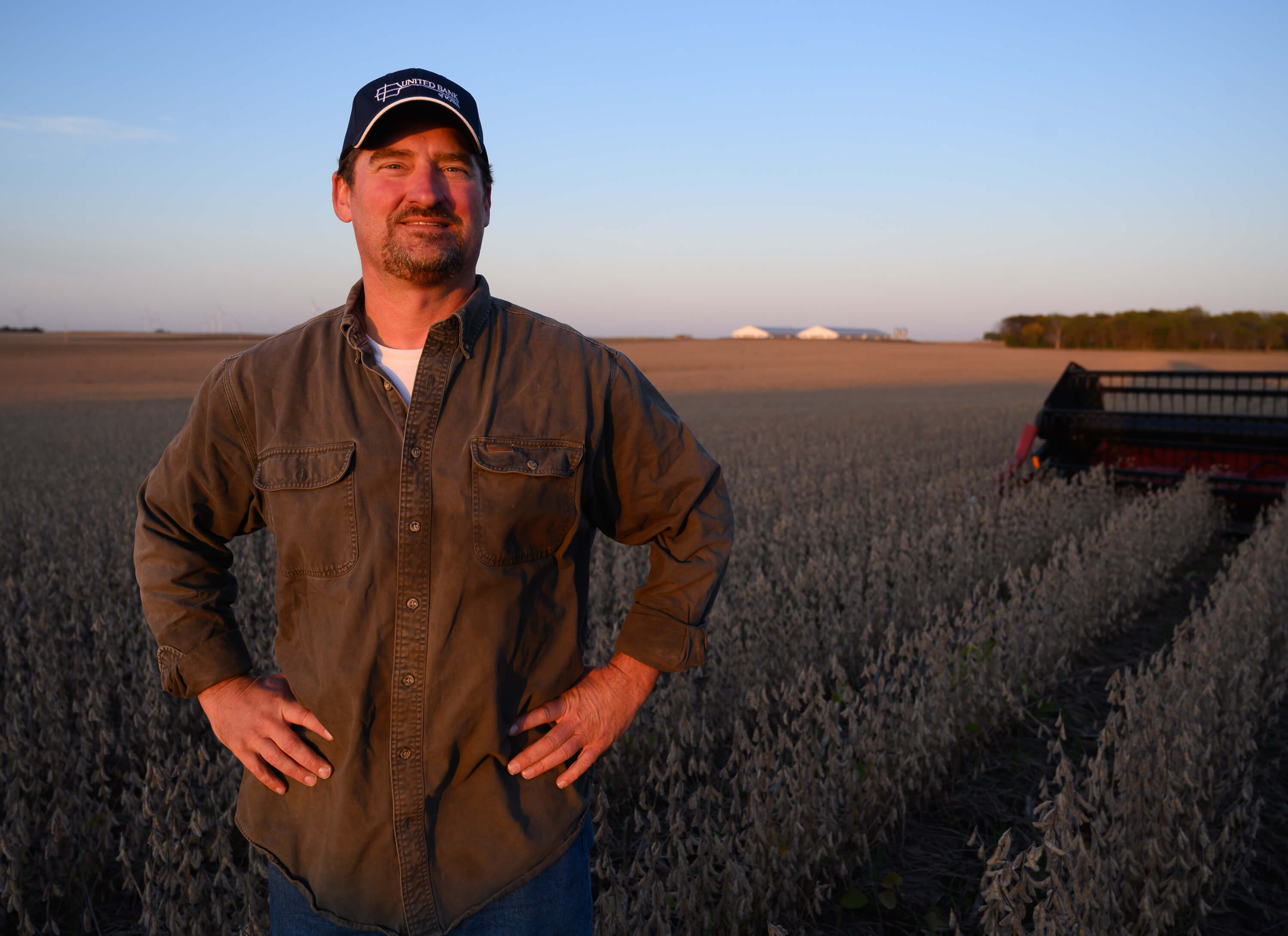 Tim Bardole poses in front of soybean field at harvest