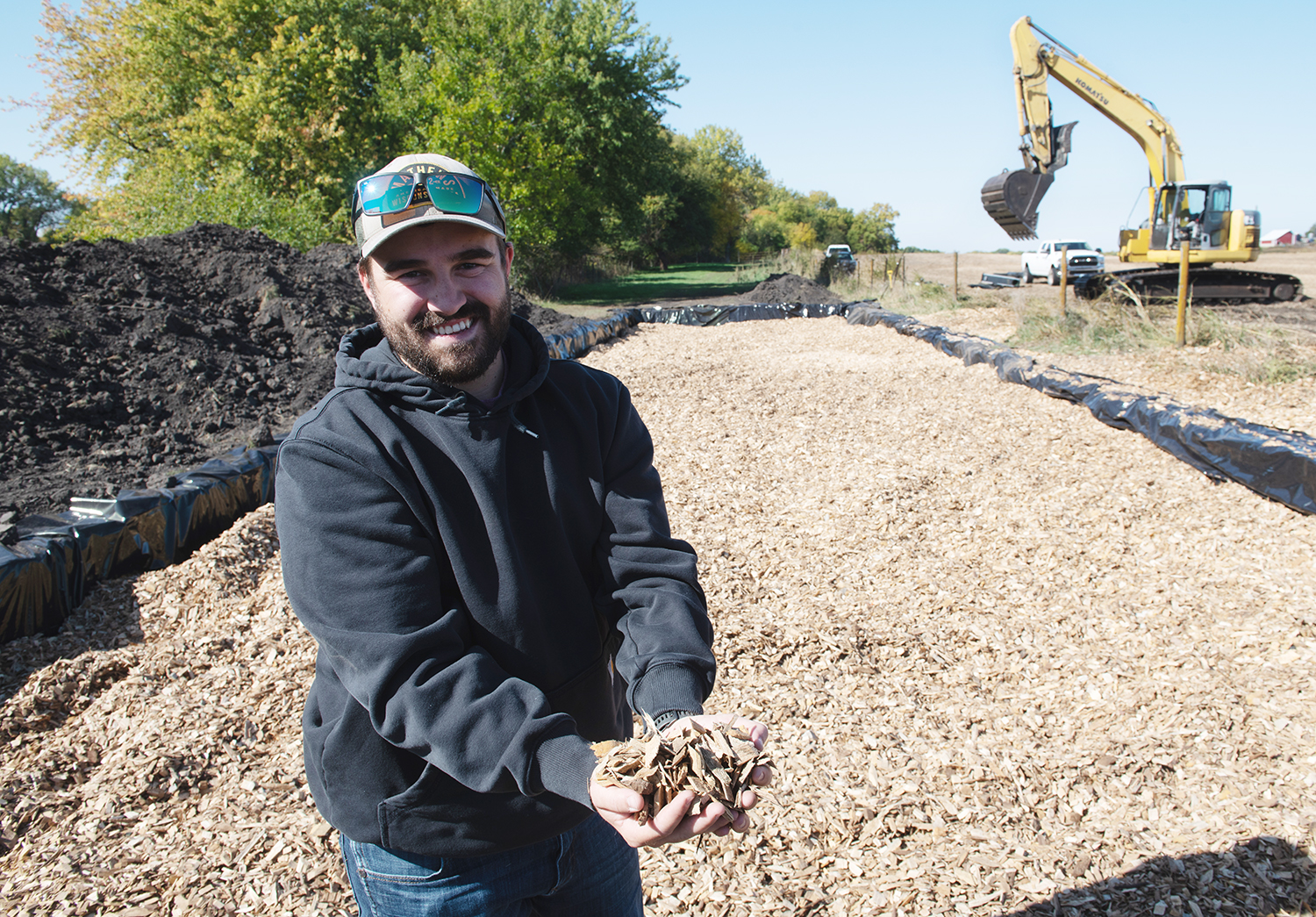 Corey McKinney holds wood chips that will be used in a 