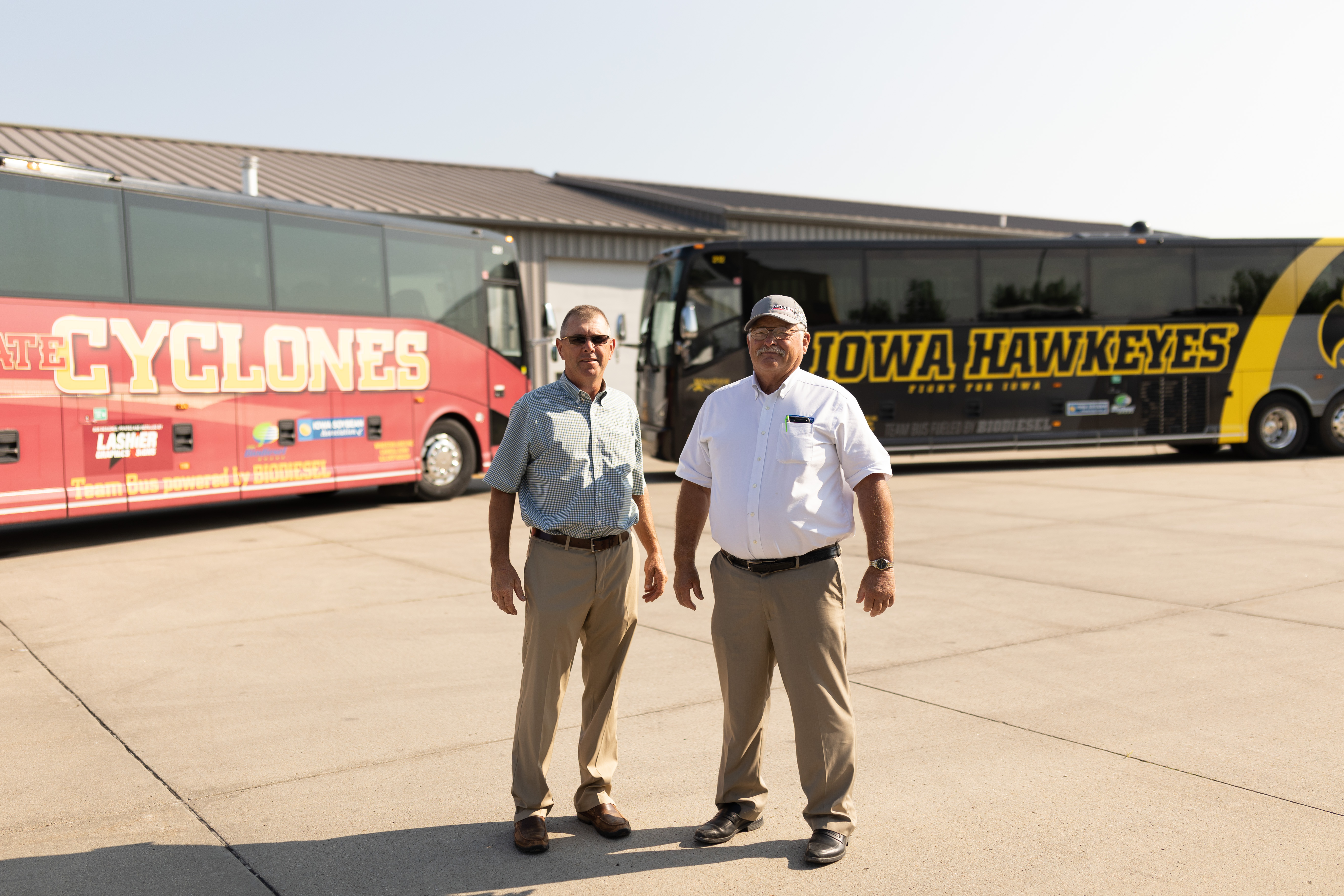 Iowa soybean farmers in front of Iowa college bio buses