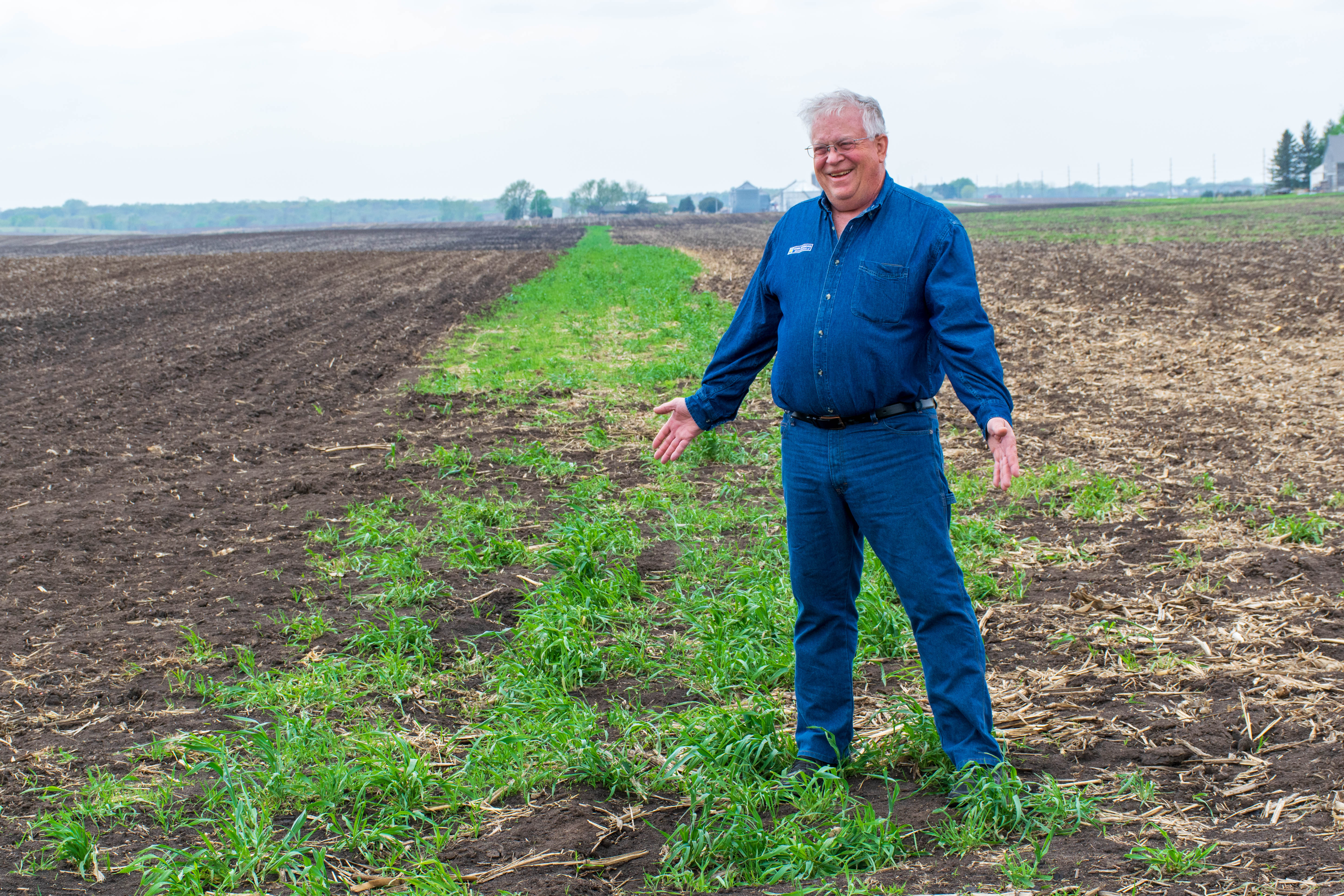 Pat Murken stands in jeans and long sleeve denim shirt 