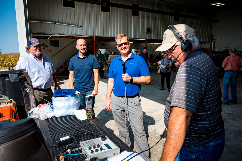 Bob Quinn visits with Roger Wolf, Jonathan Gano and Sea