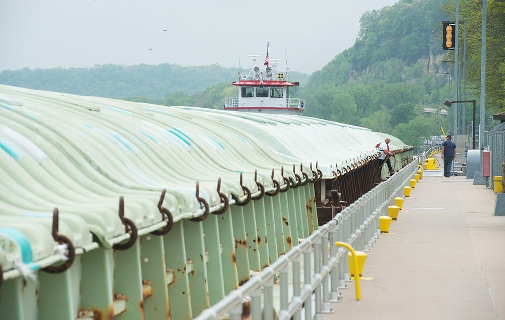 Barge workers prepare a barge to be moved through a loc