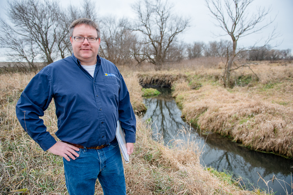 Heath stands near a stream.