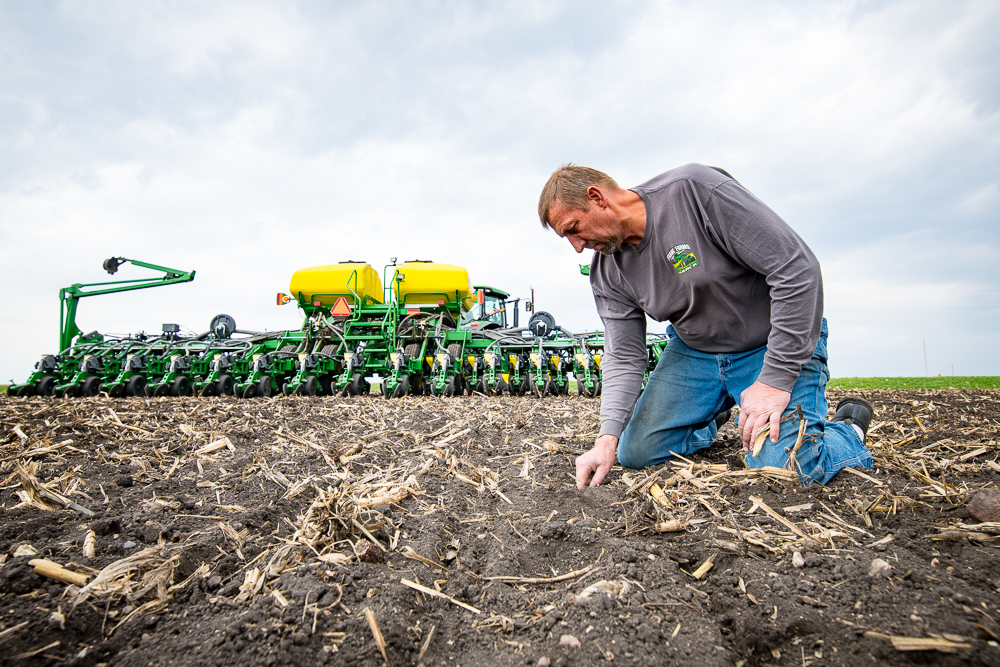 Jeff Frank examines seed depth and placement during pla