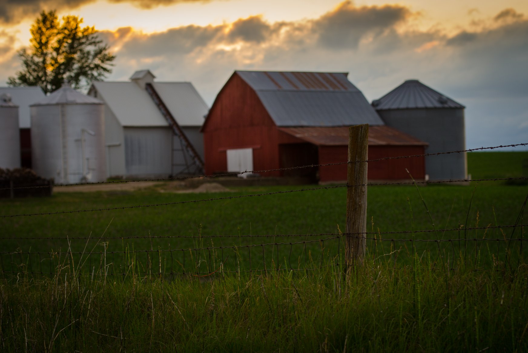 Farmstead with a sunset.