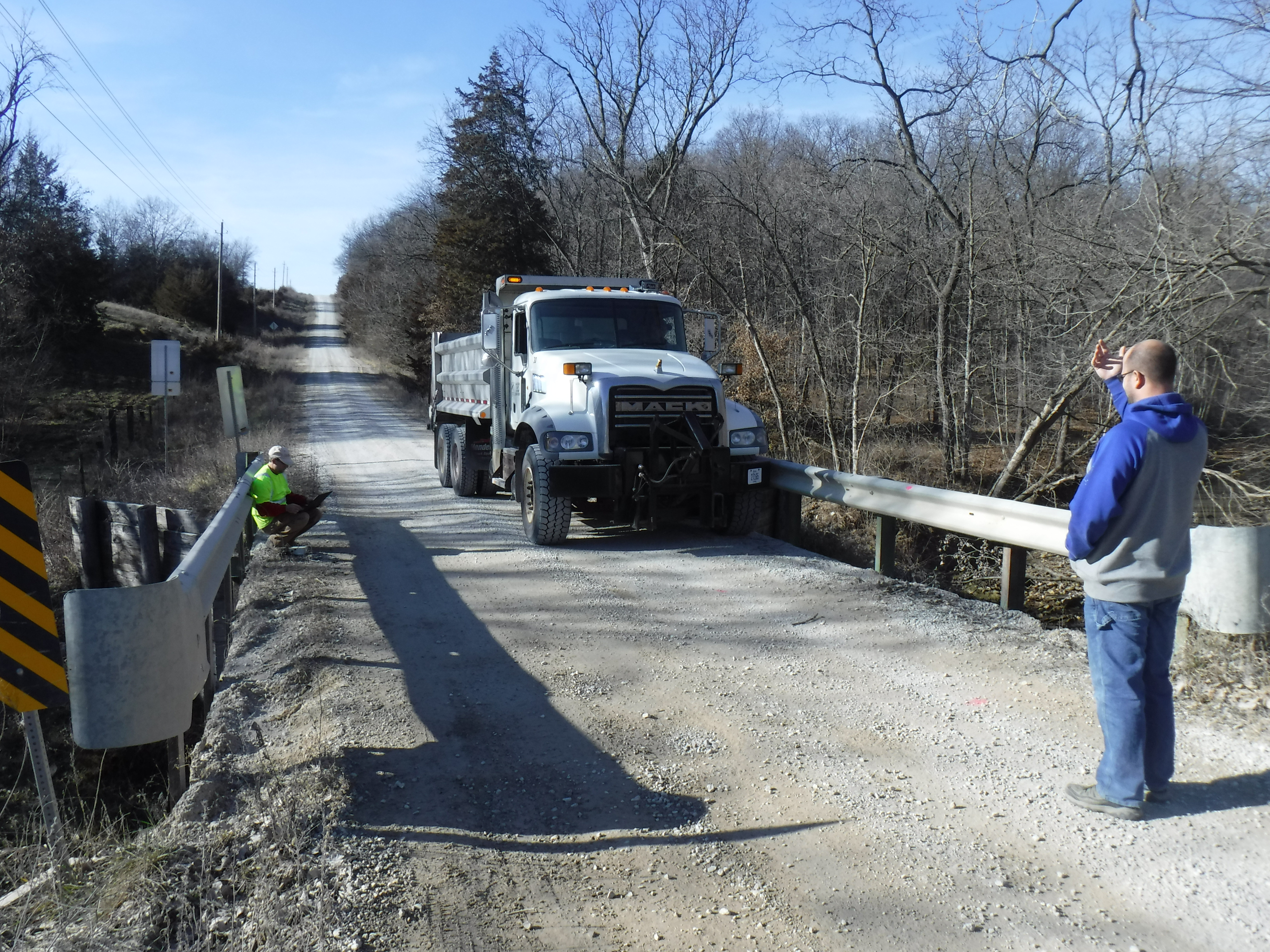 Workers conduct tests on a rural bridge