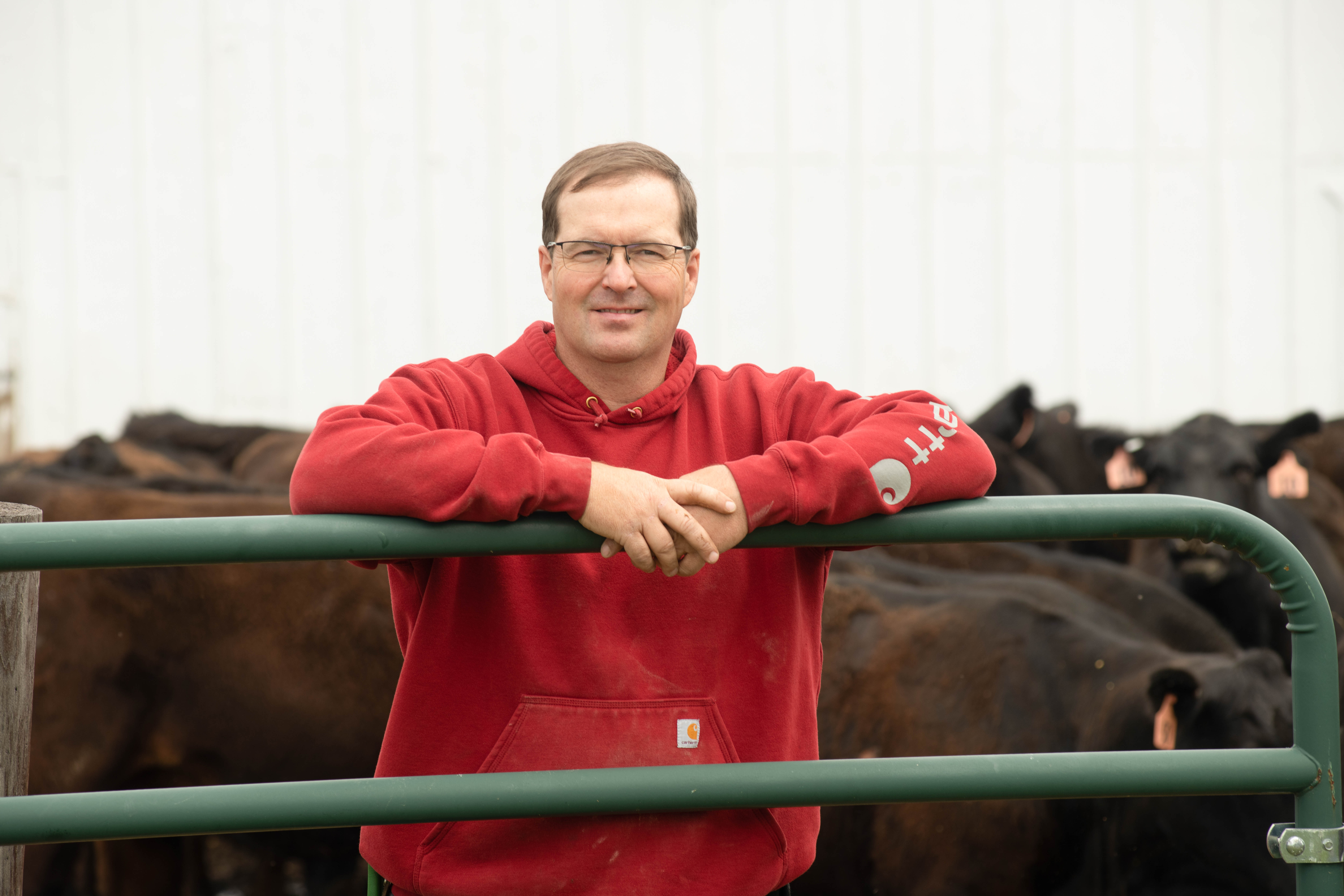 Jeff Jorgenson poses near his cattle hear