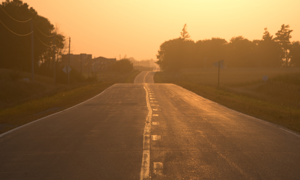 A road glows orange at sunset