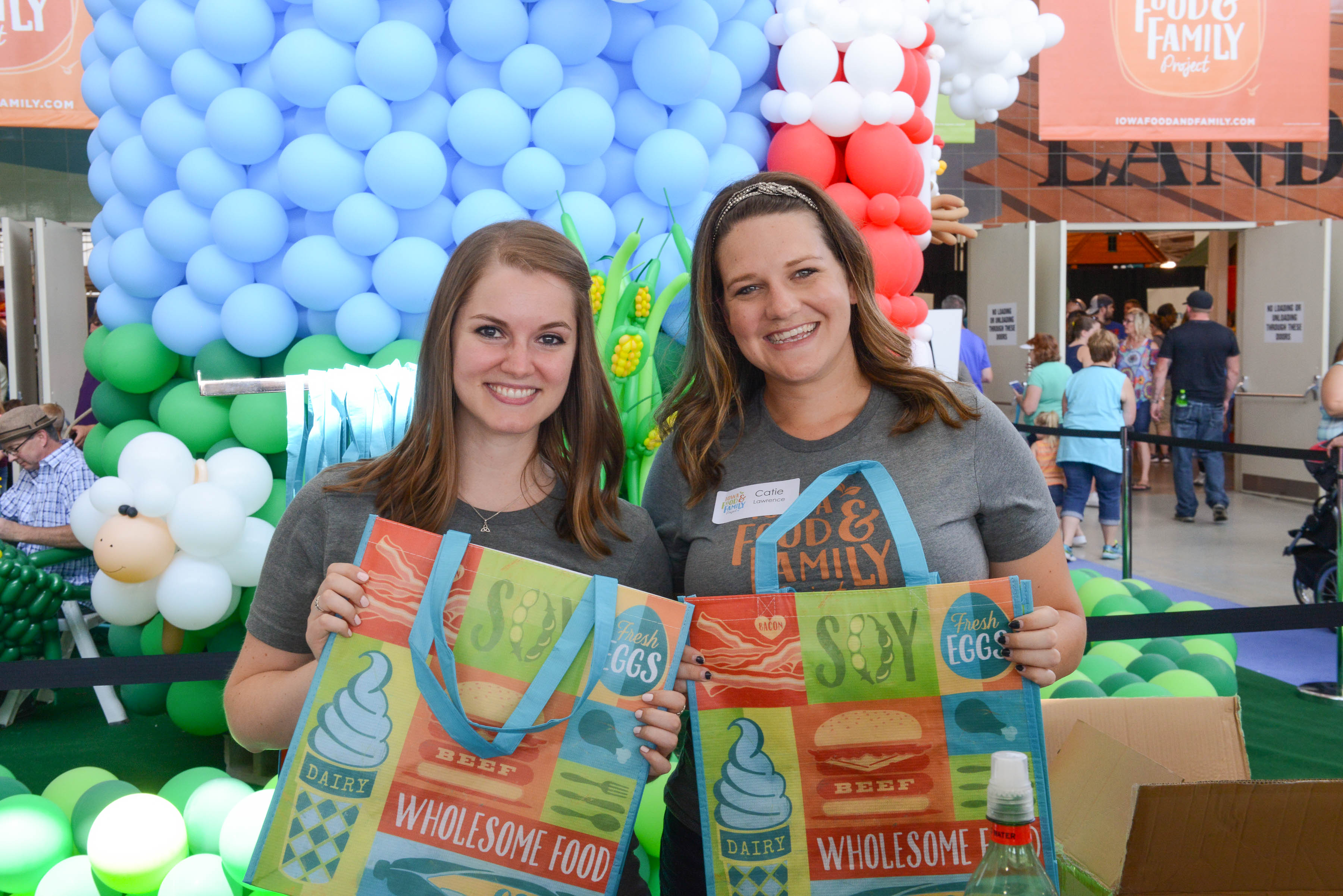 Iowa Food & Family Project volunteers hold bags at the 