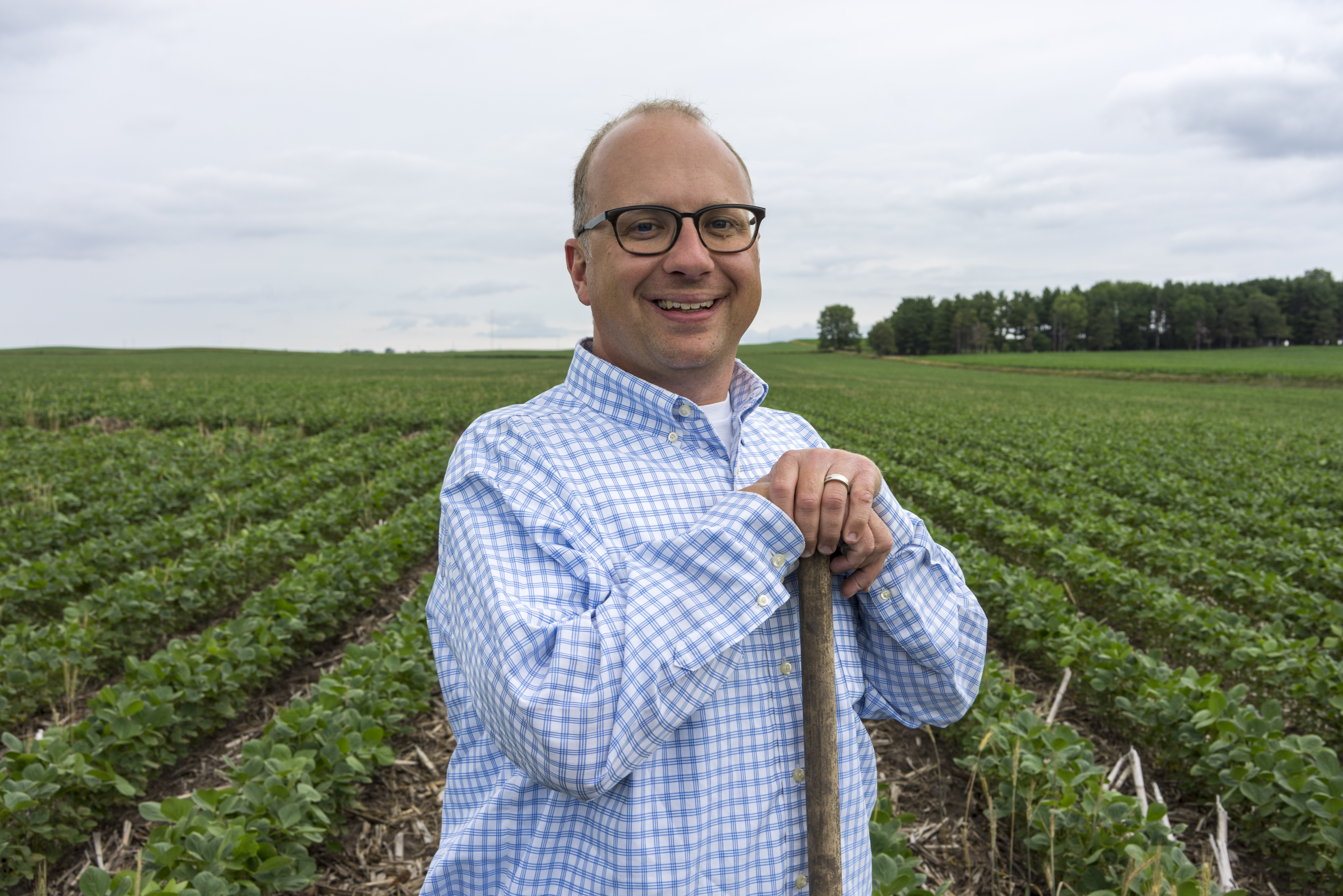 ISA farmer member Jacob Bolson stands in his soybean fi