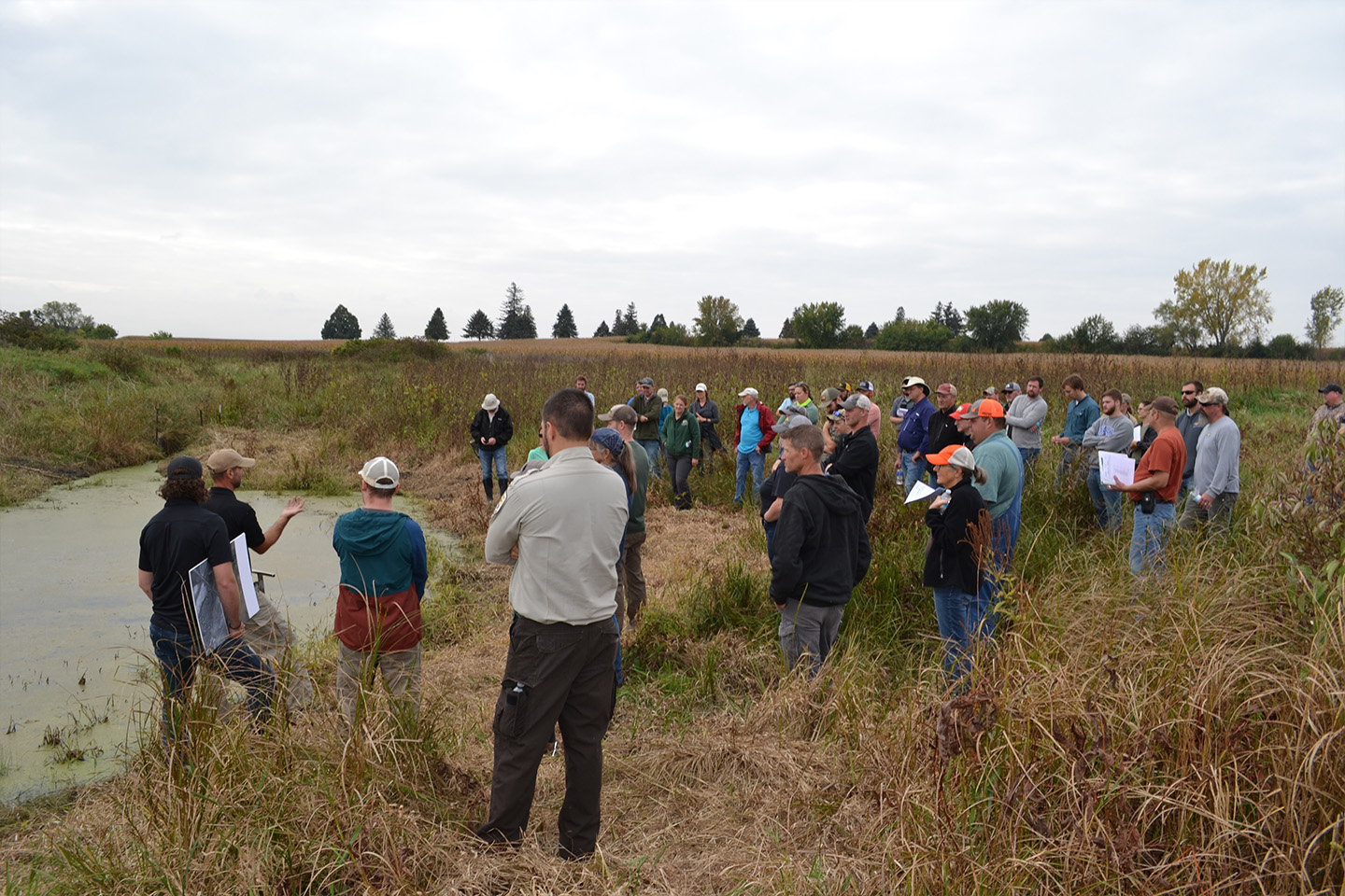 Conservation professionals explore a restored oxbow rec