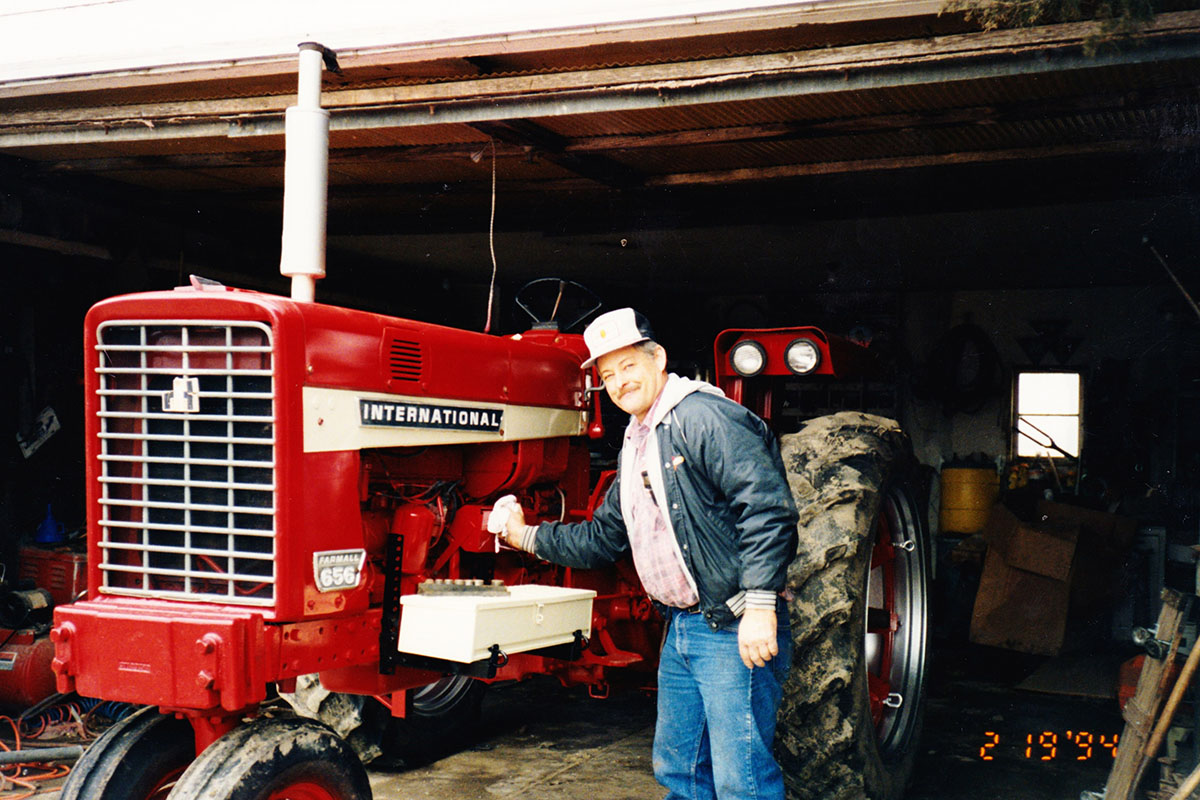 Warren Bachman working on IH tractor International Harvester Tractor