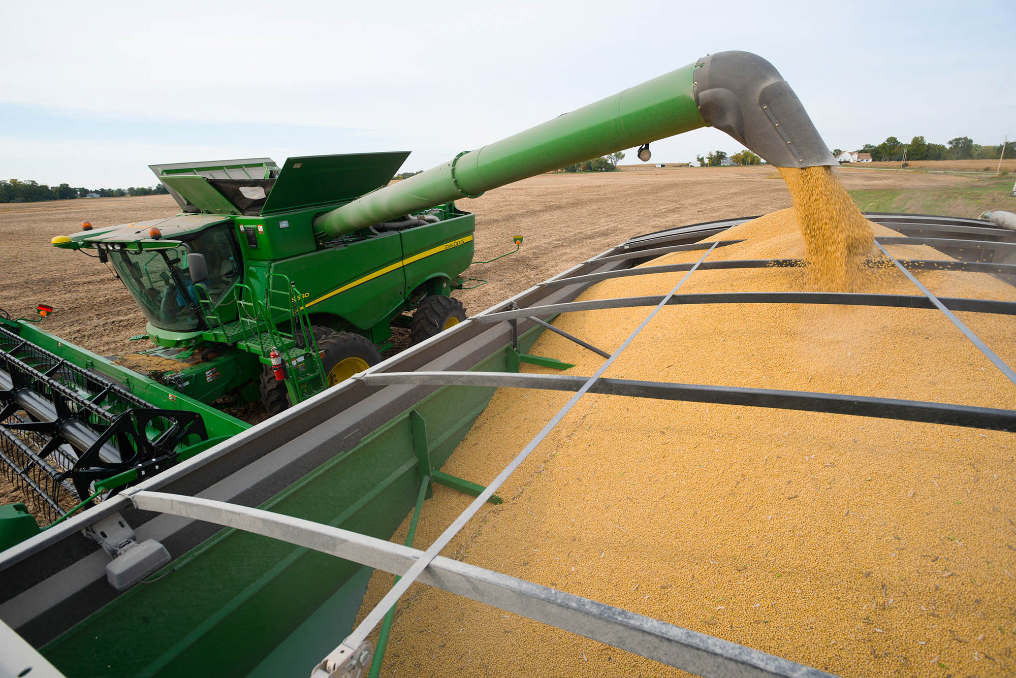 Combine unloading soybeans John Deere combine unloading beans