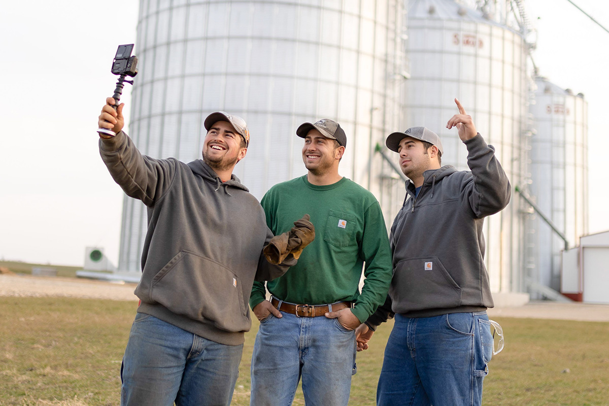 YouTube farmers next to grain bins