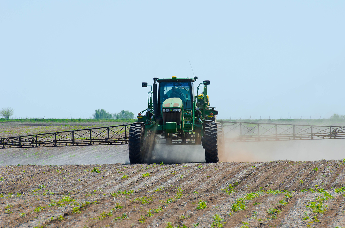 John Deere tractor in field with sprayer
