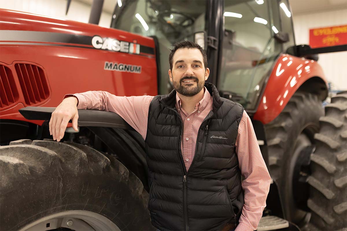 Iowa soybean grower standing next to Case IH Tractor