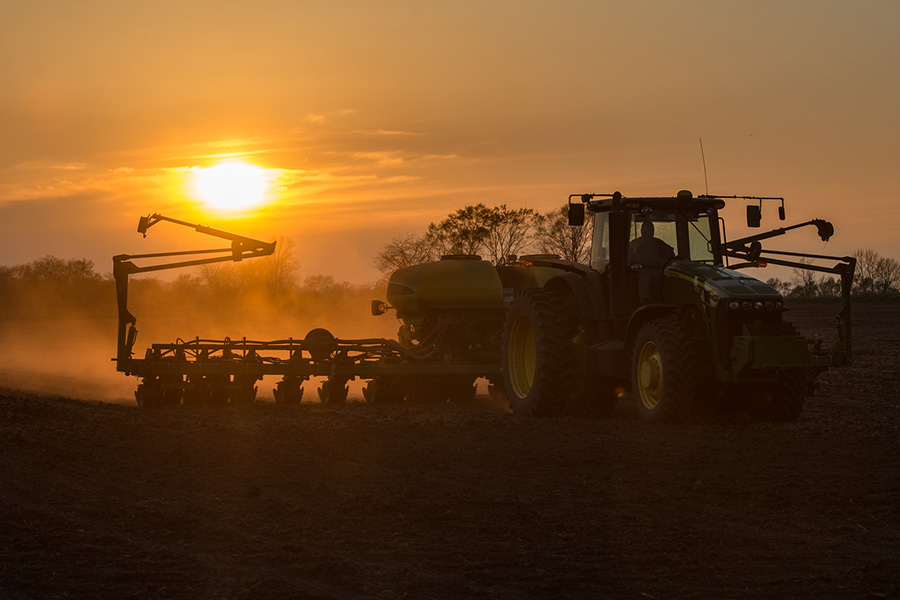 Tractor in field planting soybeans