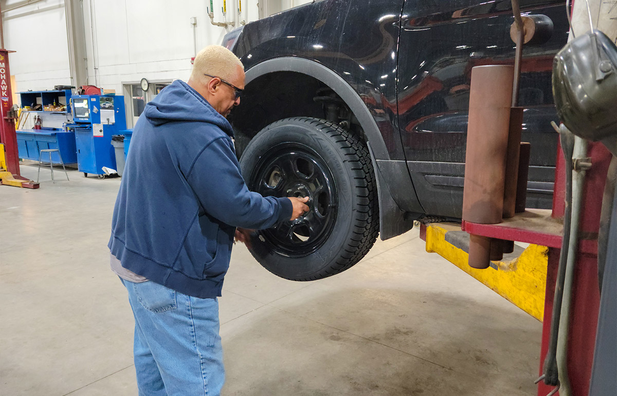 Amin Bakri installing tires in Ankeny