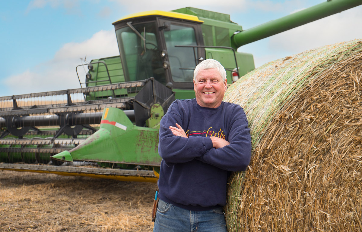 ISA farmer director standing by combine