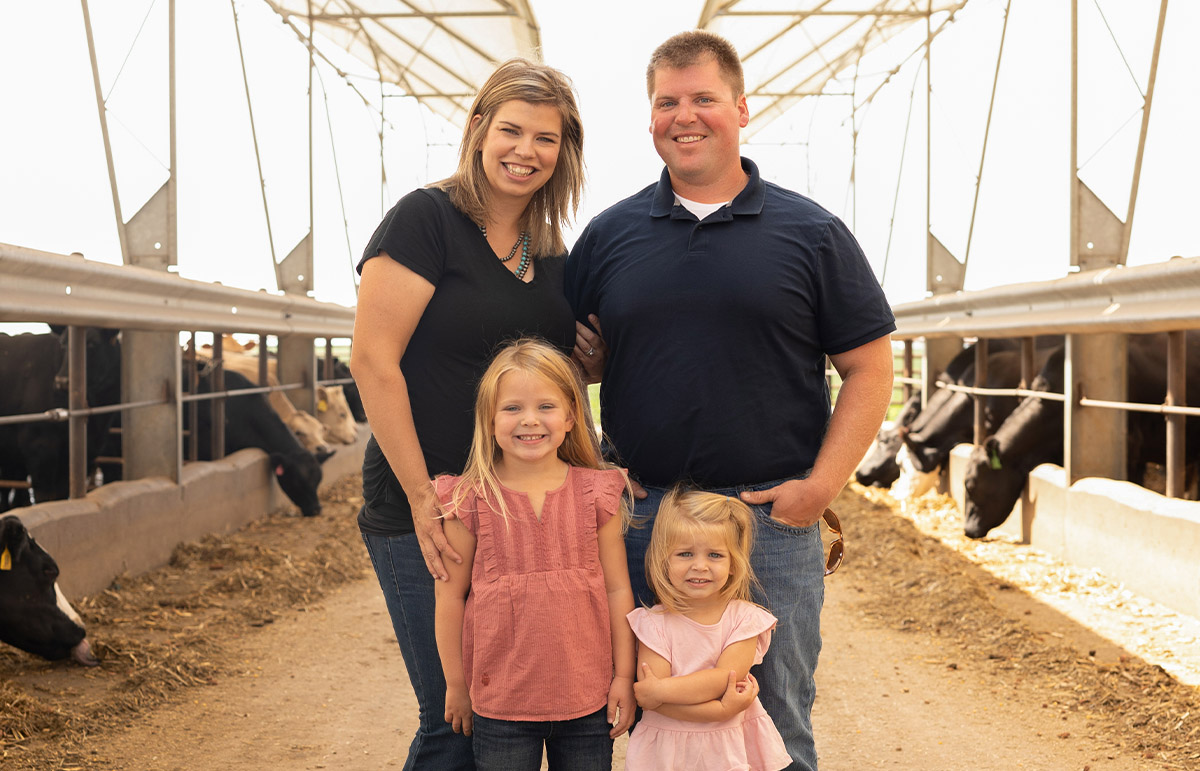 Sixth-generation farmer standing with family