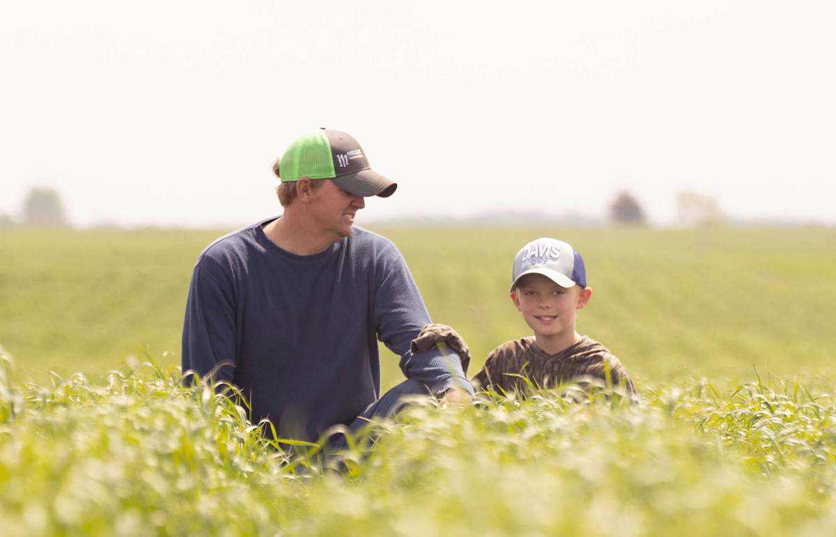 Mark and Oliver Dobson Farming and son in Iowa field