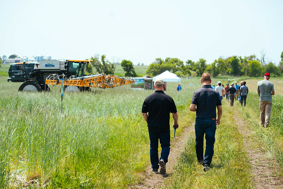 Water Quality Field Day Farmers walking through field in Iowa