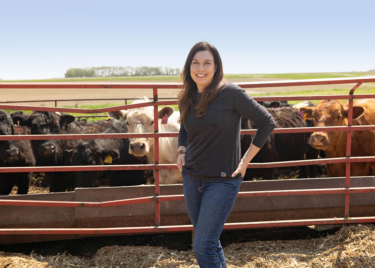 Iowa soybean farmer in front of cattle