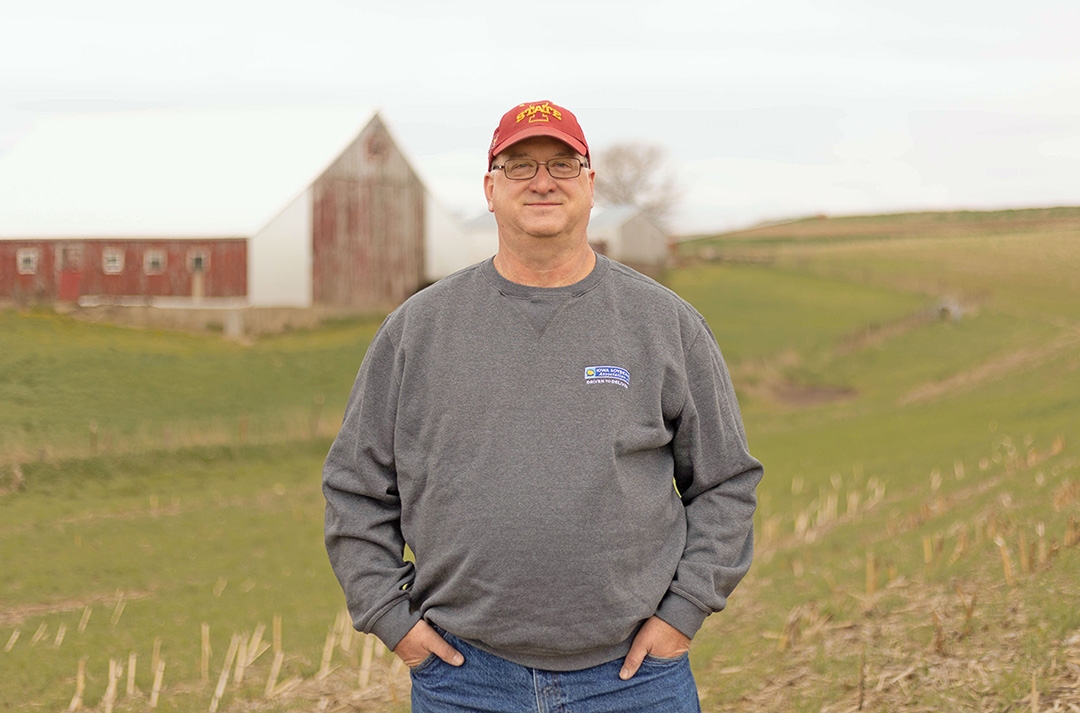 Farming standing near barns in Iowa