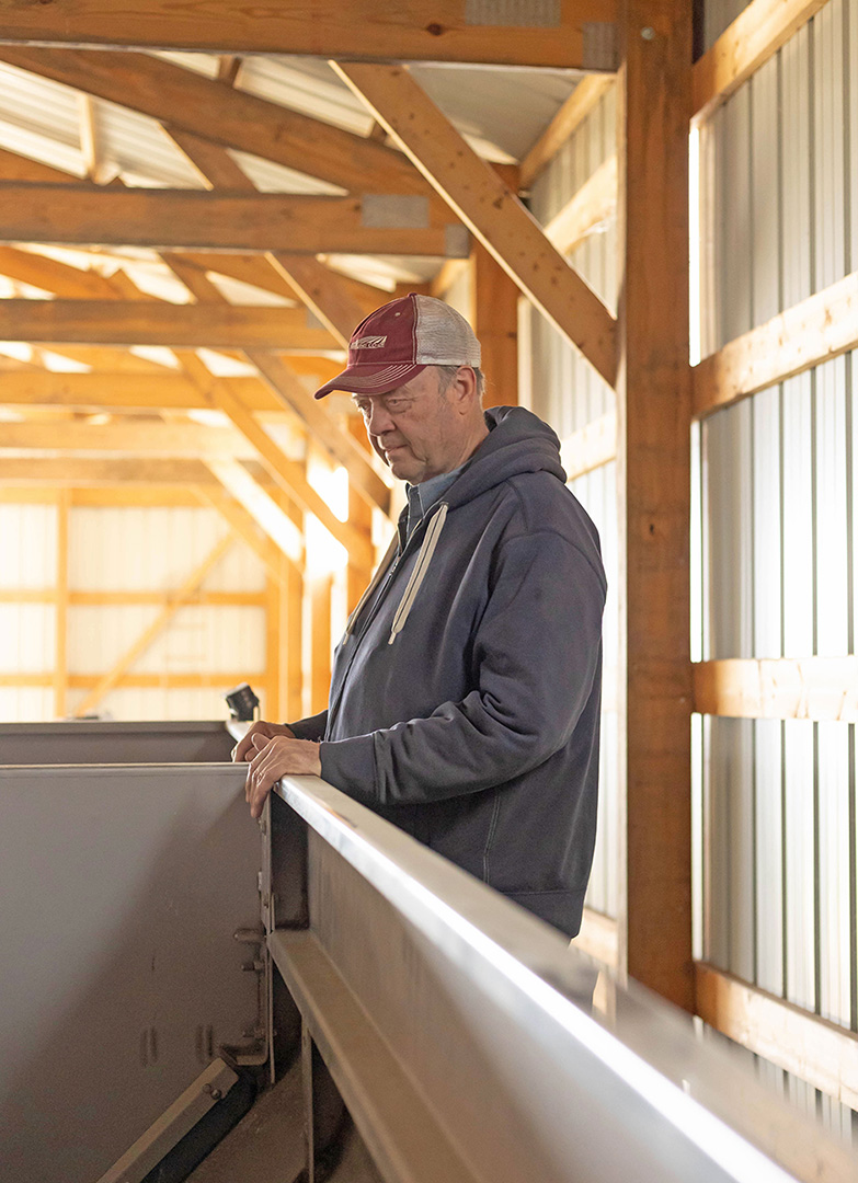 Farming looking into wagon in shed