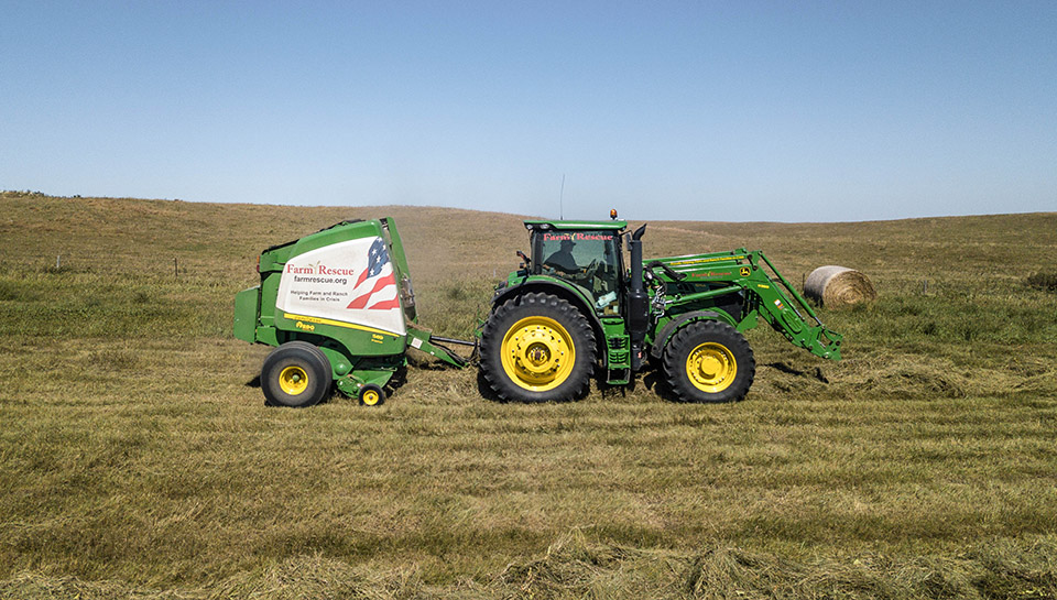 John Deere tractor in waterway making hay