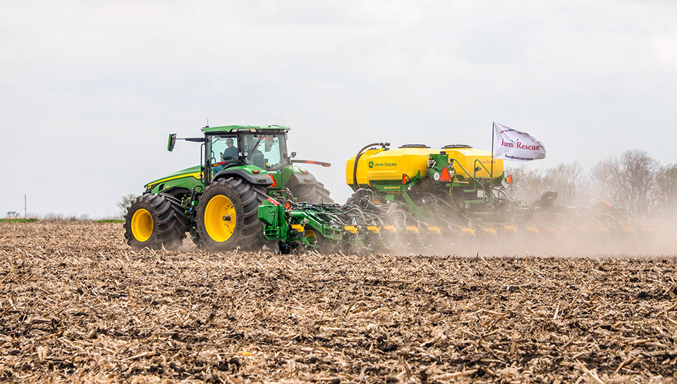 John Deere tractor in field with planter