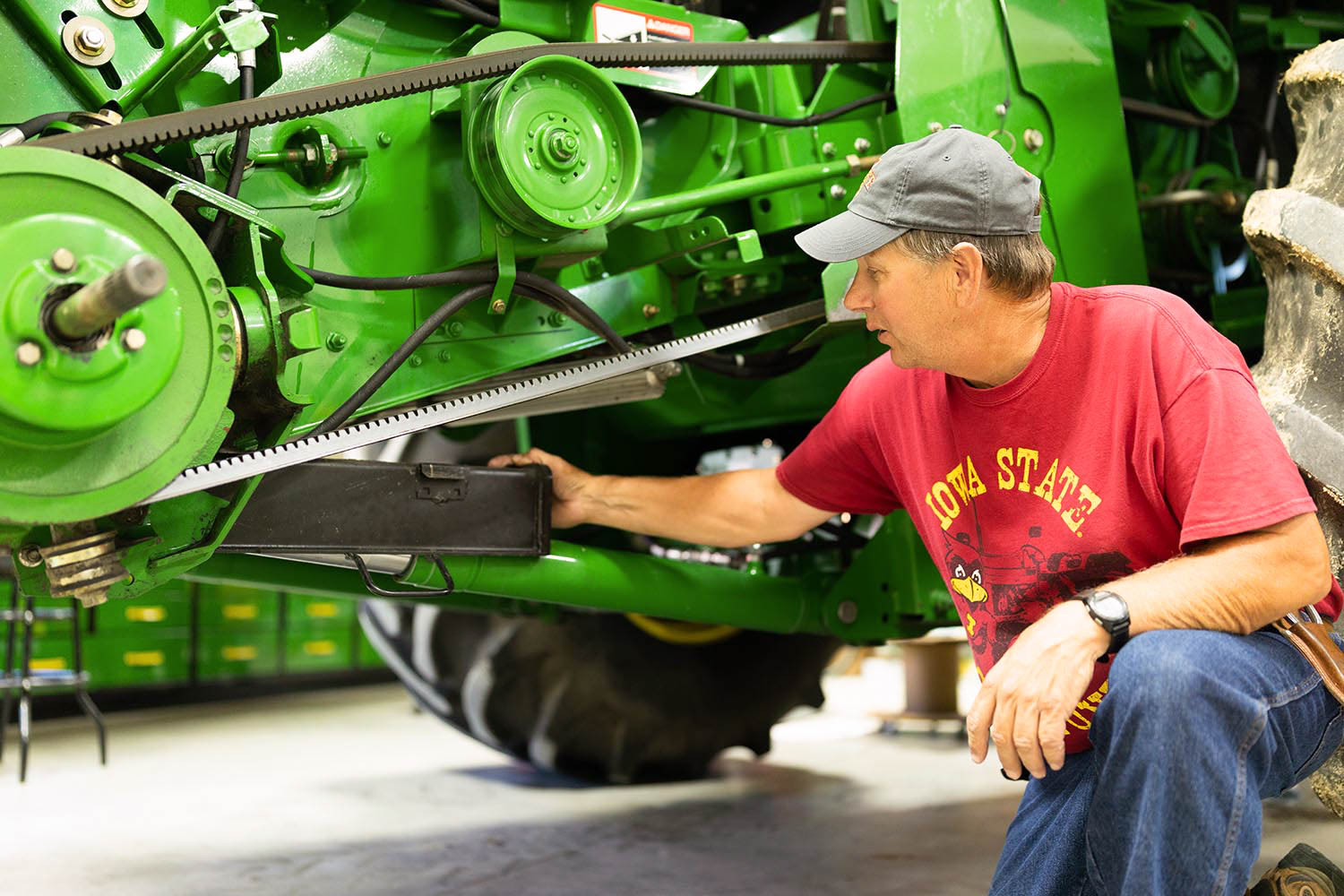 Iowa Soybean Farmer Kevin Glanz Farmer checking John Deere combine