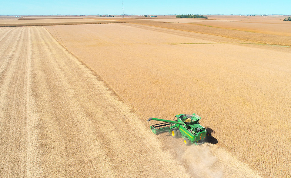 John Deere combine in soybean field