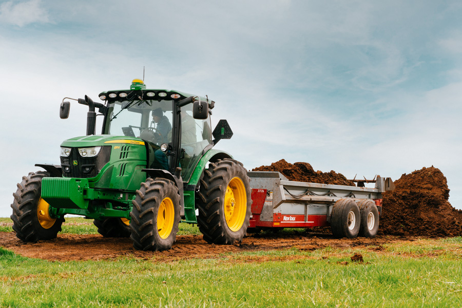 Manure spreader with John Deere tractor