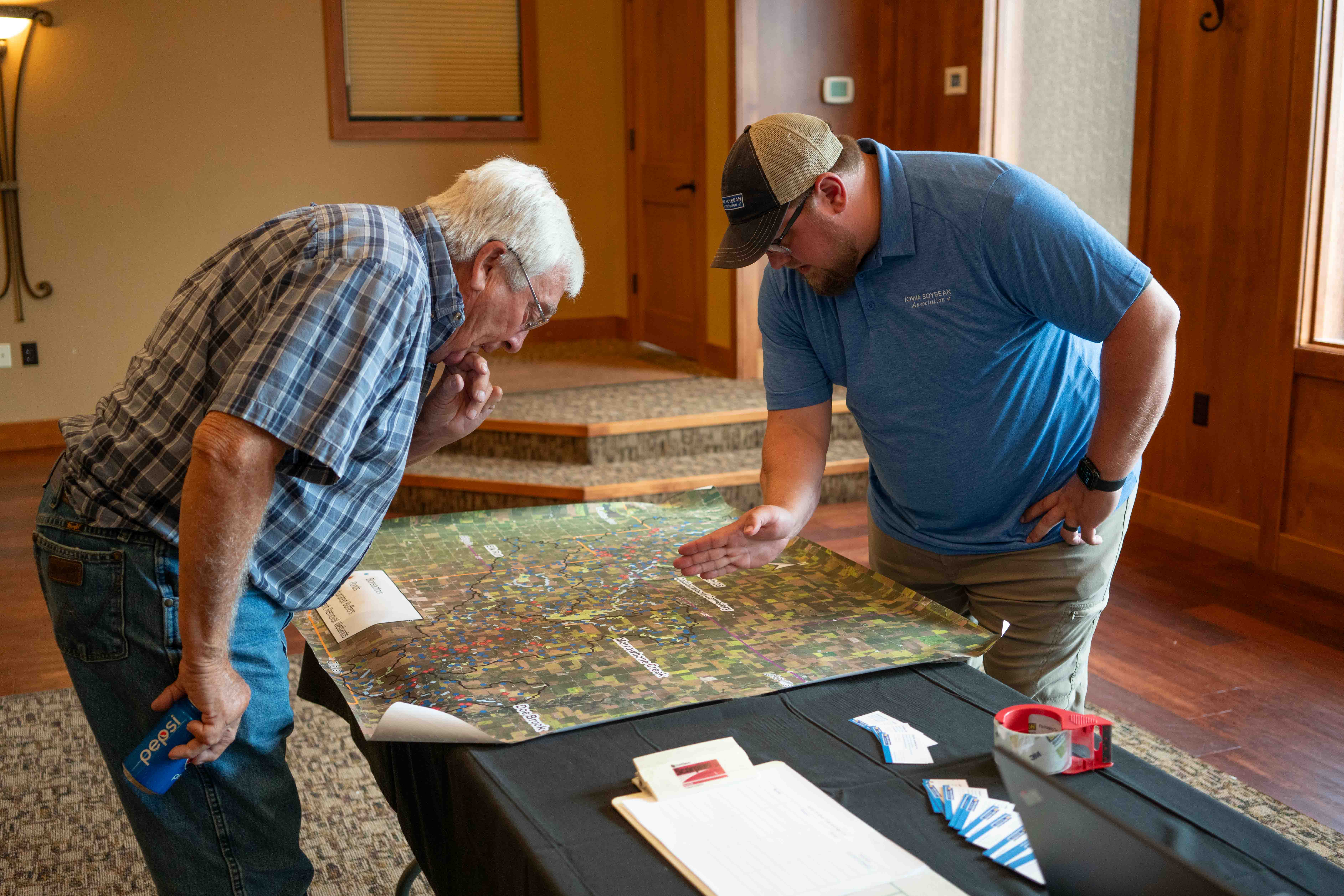 ISA staff and farmer look at map