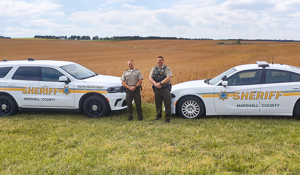 Sheriff cruisers near soybean field