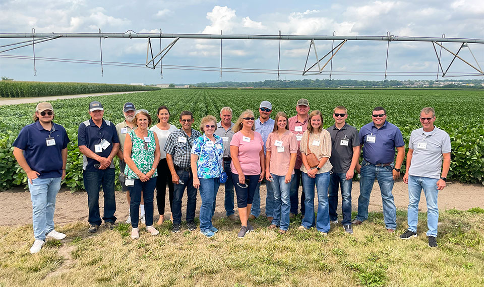 Farmers standing near soybean field