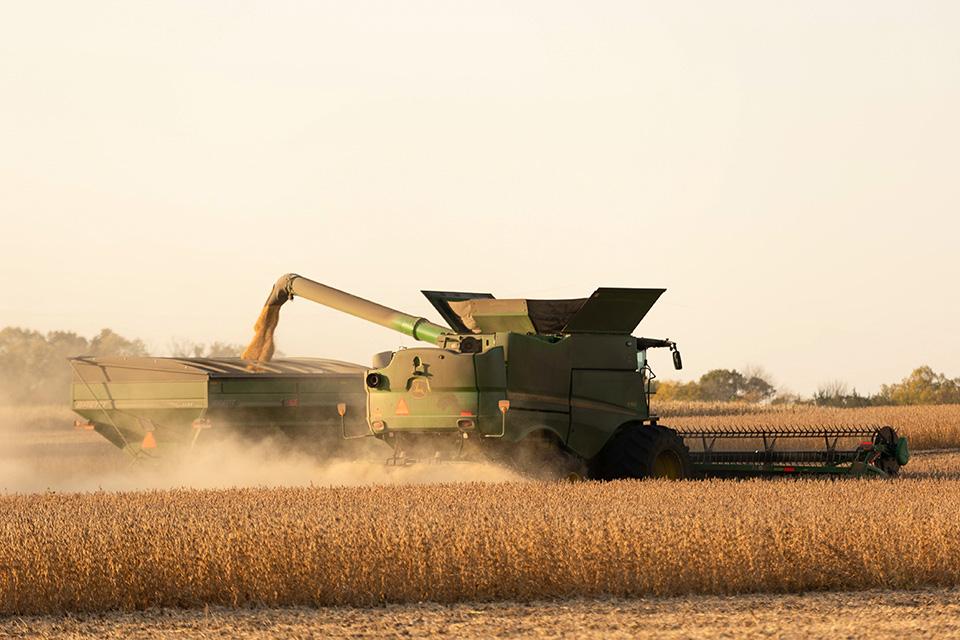 John Deere combine in soybean field