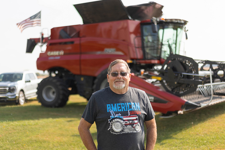 Farmer standing next to Case IH combine