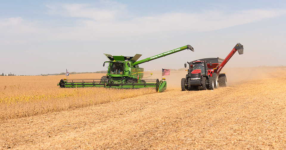 Farm Rescue helping during harvest John Deere combine in soybean field