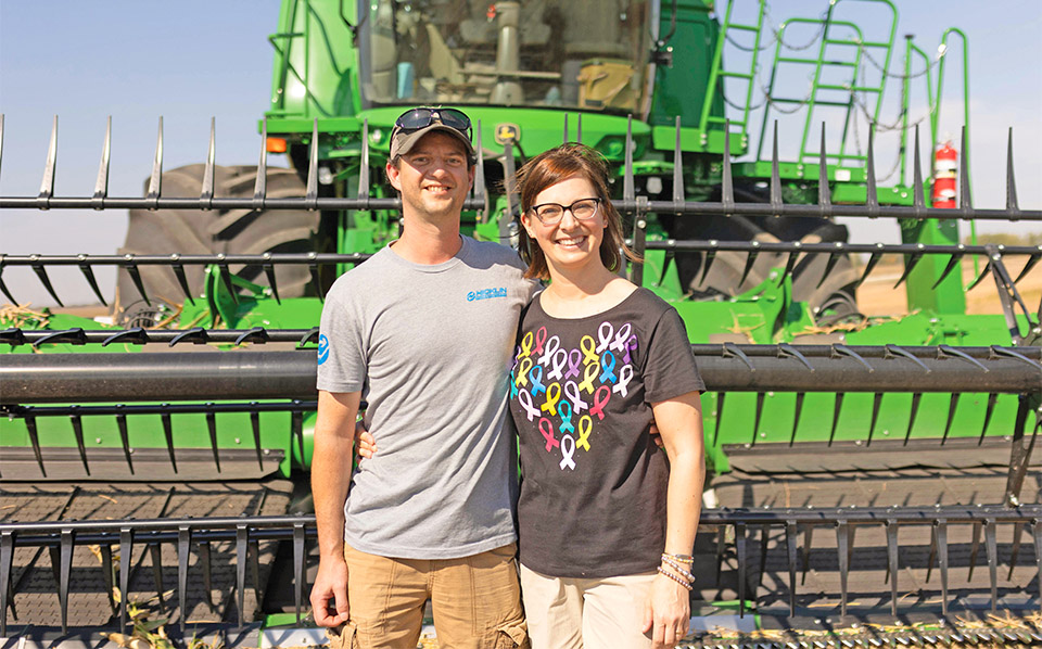 Farmers standing on farm in Iowa