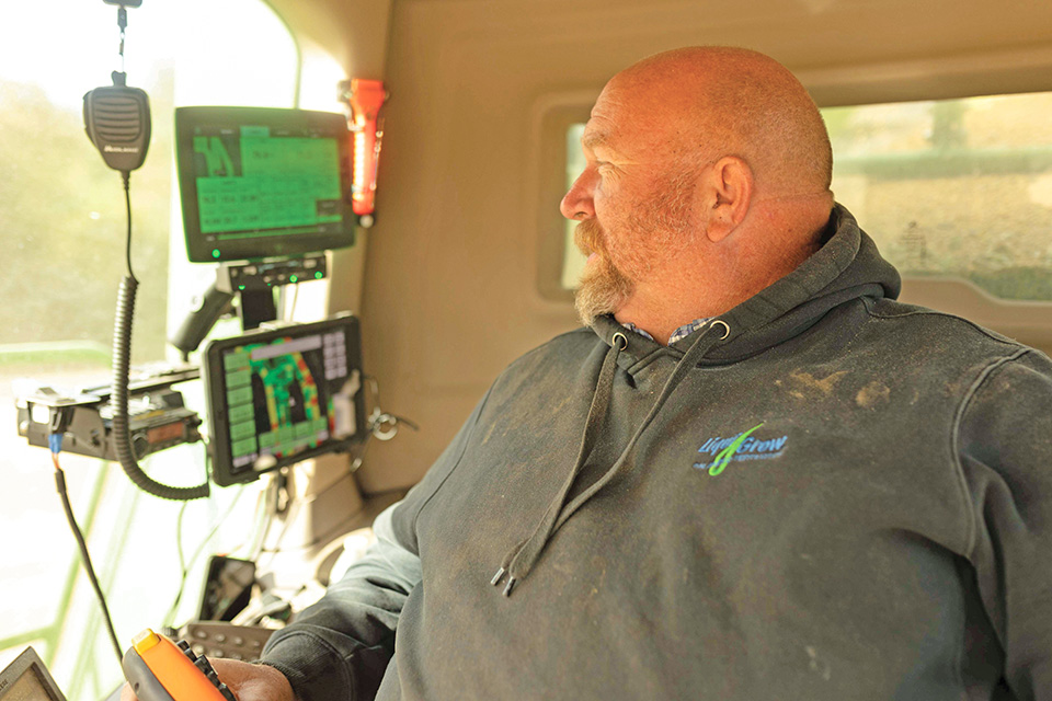 Farmer driving combine during harvest