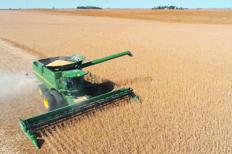John Deere combine in soybean field
