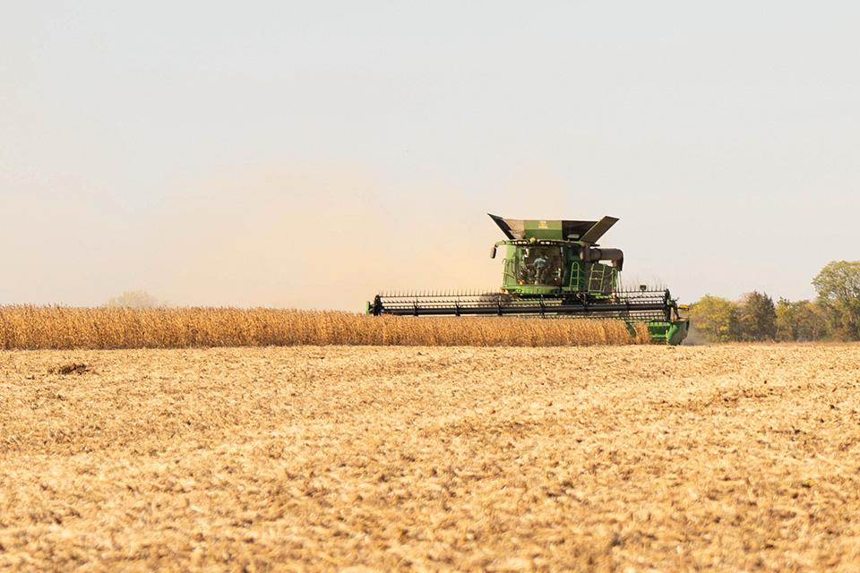 John Deere combine in soybean field