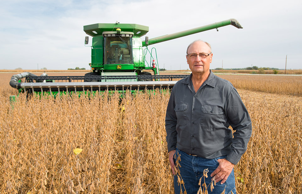 Farming champion standing in his soybean field